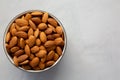 Raw Organic Almonds in a Bowl on a gray background, top view. Copy space Royalty Free Stock Photo