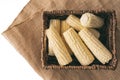 Raw organic corn in wicker basket close up isolated on white background Royalty Free Stock Photo