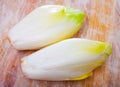 Raw organic endives on wooden table Royalty Free Stock Photo