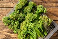 Raw Organic Fresh Broccolini Vegetable in a wooden box. Wooden background. Top view