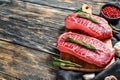 Raw organic meat Twagyu oyster top blade steak. Black wooden background. Top view. Copy space Royalty Free Stock Photo