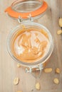 Raw organic peanut butter on wooden background