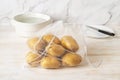 Raw organic potatoes in an eco reusable mesh bag on a white wooden table. Recycled nylon produce bags for groceries shopping and Royalty Free Stock Photo