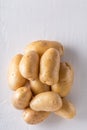 Raw organic potatoes on a white background