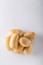 Raw organic potatoes on a white background