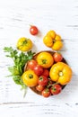 Raw organic vegetables. The concept of vegan or diet food. Fresh ripe bunch colorful tomatoes, red, yellow on a wooden table. View Royalty Free Stock Photo