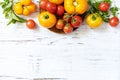 Raw organic vegetables. The concept of vegan or diet food. Fresh ripe bunch colorful tomatoes, red, yellow on a wooden table. View Royalty Free Stock Photo