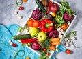 Raw organic vegetables with fresh ingredients for healthily cooking in white tray on concrete background Royalty Free Stock Photo