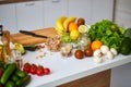 Raw organic vegetables, fruits and nuts with fresh ingredients for healthily cooking on kitchen. Vegan or diet food concept. Royalty Free Stock Photo