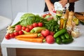 Raw organic vegetables, fruits and nuts with fresh ingredients for healthily cooking on kitchen. Vegan or diet food concept. Royalty Free Stock Photo