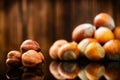 Raw Organic Whole Hazelnuts on wooden background.