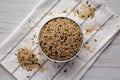Raw Organic Wild Rice in a Bowl on a white wooden background, top view Royalty Free Stock Photo