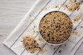 Raw Organic Wild Rice in a Bowl on a white wooden background, top view Royalty Free Stock Photo