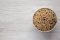 Raw Organic Wild Rice in a Bowl on a white wooden background, top view. Copy space Royalty Free Stock Photo