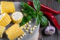 Raw Organic Yellow Corn on the Cob Ready to grill with hot chili pepper garlic and herbs. Royalty Free Stock Photo