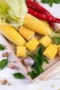 Raw Organic Yellow Corn on the Cob Ready to grill with hot chili pepper garlic and herbs. Royalty Free Stock Photo