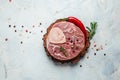 Raw Ossobuko steak marble meat with herbs and spices on dark background. banner, menu, recipe place for text, top view