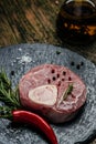 Raw Ossobuko steak marble meat, vertical image. top view. place for text