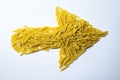 Raw pasta arrow on a white background