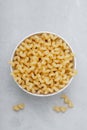 Raw pasta. Cavatappi Italian Pasta or Macaroni. Uncooked delicious pasta on gray stone background Royalty Free Stock Photo