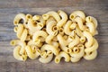 Raw pasta cavatappi on wooden background