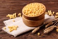 Raw pasta ditalini and rye ears in a wooden bowl Royalty Free Stock Photo