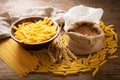 Raw pasta with flour, wheat ears and grains Royalty Free Stock Photo