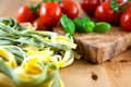 Raw pasta and fresh cherry tomatoes Royalty Free Stock Photo