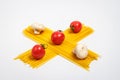 Raw pasta, fresh vegetables, tomatoes and mushrooms on a white background Royalty Free Stock Photo