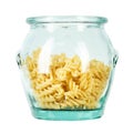 Raw pasta Fusilli in a glass jar isolated on white background. Raw and Dry Macaroni. Italian Culture. Top view Royalty Free Stock Photo