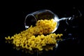 raw pasta in glass jar, wine glass. in bucket. raw pasta on black background. front view raw pasta, dropped from hand, place for Royalty Free Stock Photo