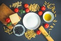 Raw pasta and ingredients for cooking around empty plate Royalty Free Stock Photo