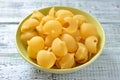 Raw pasta in a large dish on table close-up