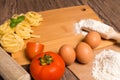 Raw pasta, tomato and eggs Royalty Free Stock Photo