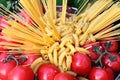 Raw pasta and tomatoes Royalty Free Stock Photo