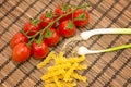 Raw pasta, tomatoes and onions Royalty Free Stock Photo
