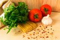 Raw pasta with tomatoes and spices and herbs on the table Royalty Free Stock Photo