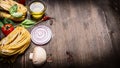 Raw pasta with vegetables and spices, butter and herbs on wooden rustic background top view border, place text Royalty Free Stock Photo