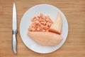 Raw peeled and chopped sweet potatoes in white plate on wood board background with sharp knife Royalty Free Stock Photo