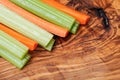 Raw peeled and cut Organic Celery Stalks and Orange Carrots arranged on olive wood. Apiaceae or Umbelliferae family. Delic