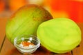 Raw and peeled mango behind a salt and chilli powder bowl Royalty Free Stock Photo