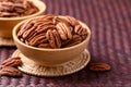 Raw peeled pecan nuts in wooden bowl
