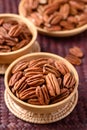 Raw peeled pecan nuts in wooden bowl