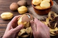 Raw peeled potatoes in bowl on dark wooden background Royalty Free Stock Photo