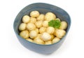 Raw peeled young potatoes with parsley in water in bowl Royalty Free Stock Photo