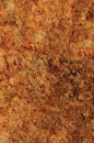 Raw pegmatite feldspar igneous rock terracotta pattern, rusty orange red golden amber yellow vertical background, coarse light