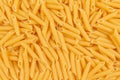 Raw penne pasta background. Close up of uncooked penne pasta