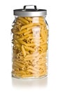 Raw penne pasta in glass jar Royalty Free Stock Photo