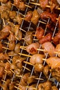 Raw piece of meat pork chicken flavored curry strung on wooden skewer on background of iron grill background Royalty Free Stock Photo