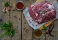 Raw piece meat of pork and spices marinade on wooden background. For steak, roasting, stewing. Space for text Royalty Free Stock Photo